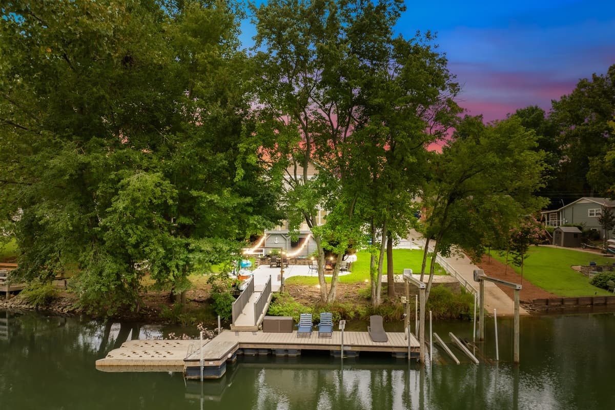 Sunset views from above showcase the dock and wooded shoreline at Moonlit Marina.