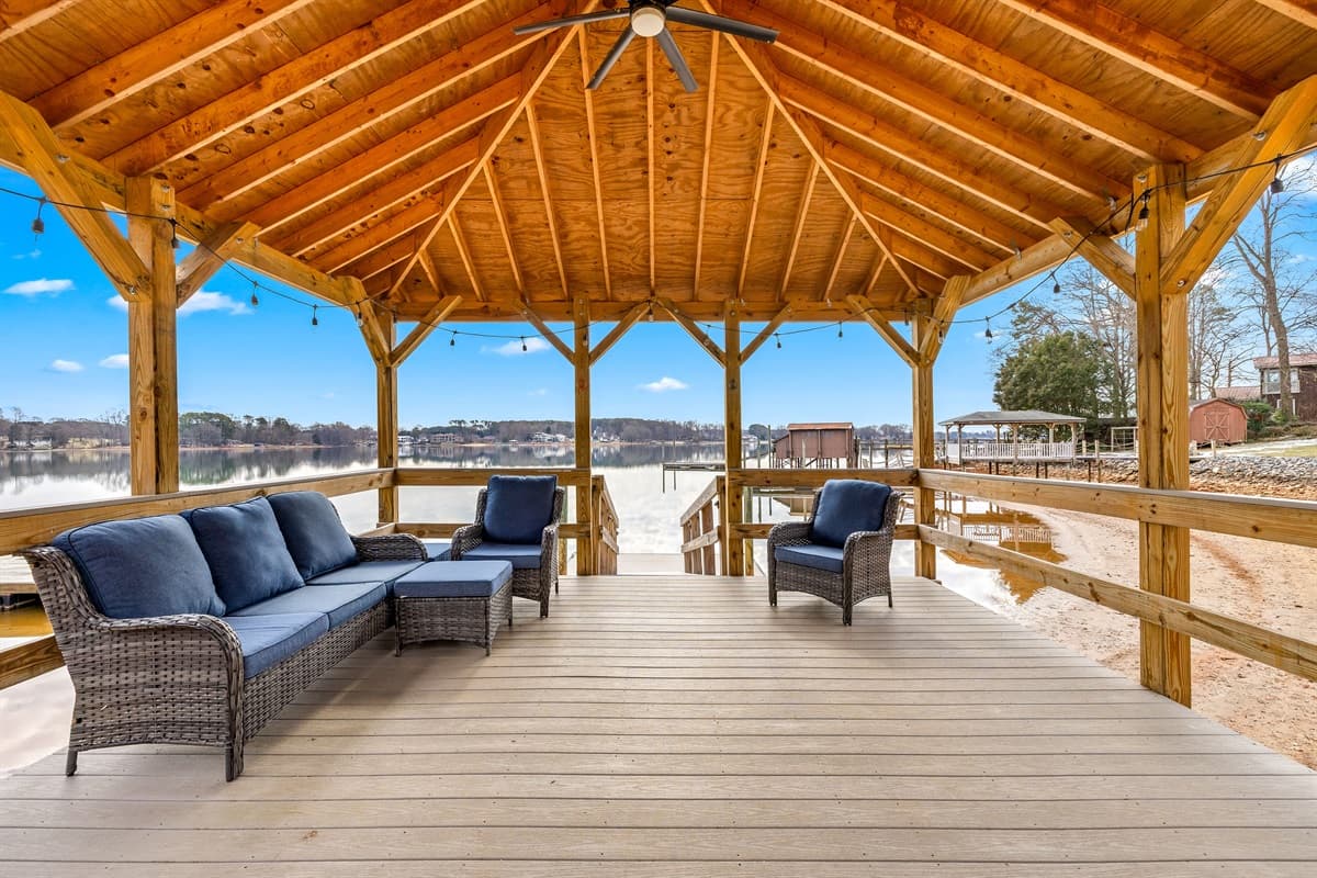 The covered outdoor pavilion is furnished with wicker seating, a shaded spot to relax outside.