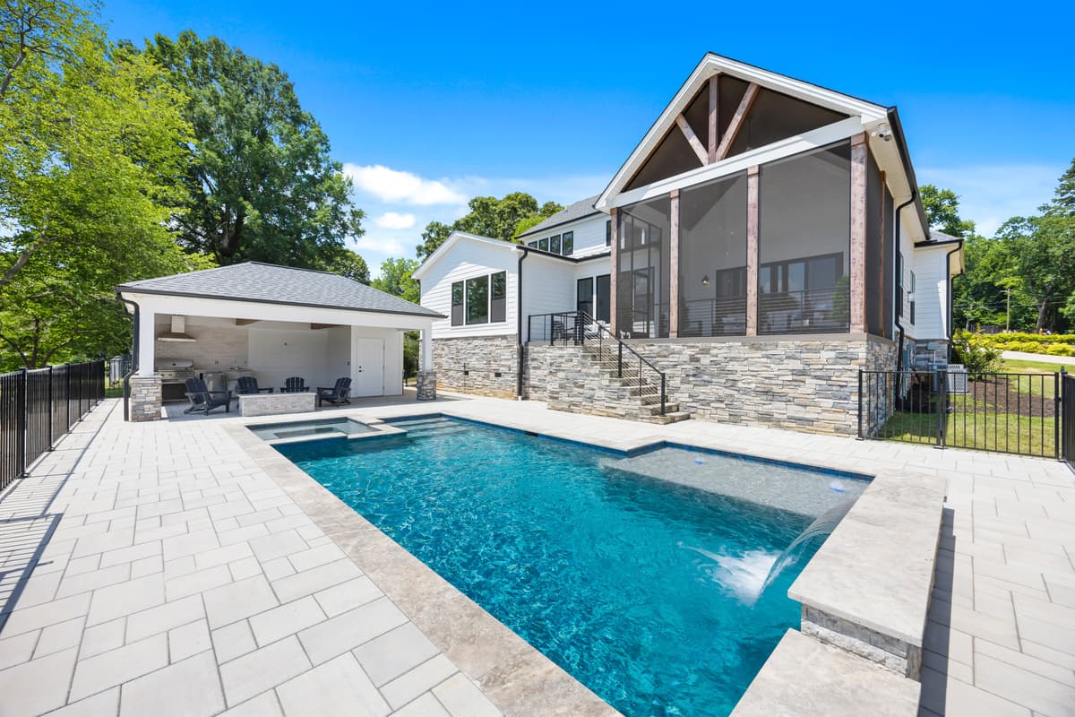 Sink into vacation mode beside your own private pool, framed by a sun-warmed stone patio and a breezy covered lounge — the perfect spot to unwind at Aqua Vista.